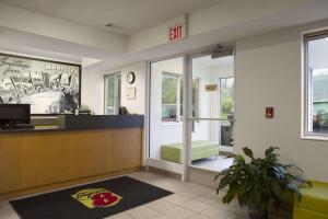 a lobby with a waiting room with a cash register at Super 8 by Wyndham Manistee in Manistee
