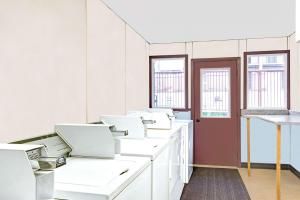 a room with white sinks and a red door at Days Inn by Wyndham Washington in Washington