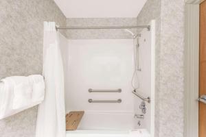 a bathroom with a shower with a white tub at Super 8 by Wyndham Erwin in Erwin