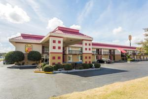 a large motel building with a parking lot at Super 8 by Wyndham Tifton in Tifton