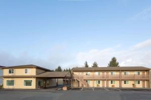 a building with a parking lot in front of it at Super 8 by Wyndham Crescent City in Crescent City