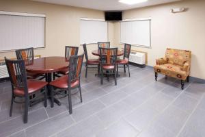 a dining room with a table and chairs at Super 8 by Wyndham Dwight in Dwight