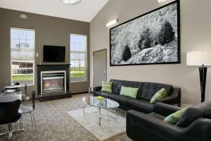 a living room with a couch and a fireplace at Super 8 by Wyndham Stafford/Springfield Area in Strafford