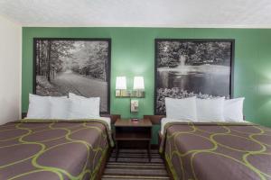 Postel nebo postele na pokoji v ubytování Syracuse Inn