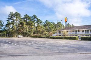 an empty parking lot in front of a building at Super 8 by Wyndham Monticello in Monticello