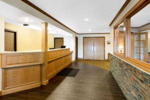a large room with a wooden floor and a large window at Super 8 by Wyndham St. Ignace in Saint Ignace