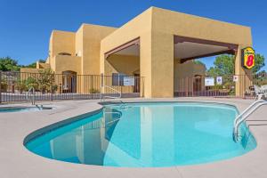 a swimming pool in front of a building at Super 8 by Wyndham Cottonwood in Cottonwood