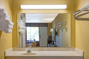 a bathroom with a sink and a large mirror at Super 8 by Wyndham Jessup/Baltimore Area in Jessup