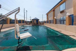 a swimming pool at a hotel with a slide at Super 8 by Wyndham Hammond in Hammond