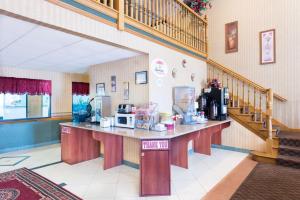 a coffee shop with a counter in a room at Super 8 by Wyndham Troy IL/St. Louis Area in Troy