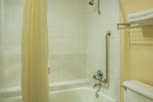 a bathroom with a tub and a shower with a shower curtain at Super 8 by Wyndham San Marcos in San Marcos