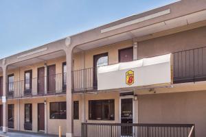 an exterior view of a building with balconies at Super 8 by Wyndham Camp Springs/Andrews AFB DC Area in Camp Springs