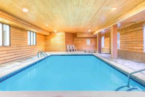 a swimming pool in a wood paneled house at Super 8 by Wyndham Buena Vista in Buena Vista