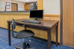 a desk with a computer on it with a chair at Super 8 by Wyndham Potosi in Potosi