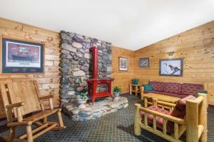 a living room with a stone fireplace and a couch at Super 8 by Wyndham McCall in McCall