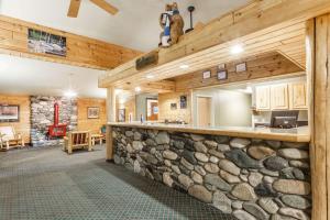 a large lobby with a stone bar in a house at Super 8 by Wyndham McCall in McCall
