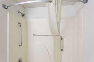 a shower in a bathroom with a shower curtain at Super 8 by Wyndham Park City/North Wichita Area in Park City