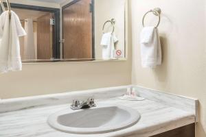 a bathroom with a sink and a mirror at Super 8 by Wyndham Luverne in Luverne +8 photos