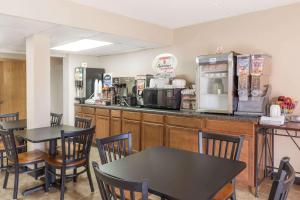 a fast food restaurant with two tables and a counter at Super 8 by Wyndham Luverne in Luverne