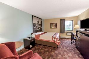 a hotel room with a bed and a desk at Super 8 by Wyndham Luverne in Luverne