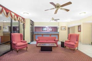 a living room filled with furniture and a red couch at Super 8 by Wyndham Bulls Gap Greeneville Area in Bulls Gap