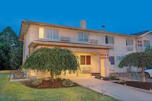 a house with a tree in front of it at Super 8 by Wyndham Canonsburg/Pittsburgh Area in Canonsburg