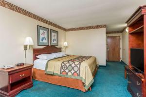 a hotel room with a bed and a flat screen tv at Super 8 by Wyndham Piedmont Greenville Area in Piedmont +22 photos