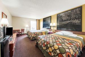 a hotel room with two beds and a flat screen tv at Super 8 by Wyndham Shepherdsville - Louisville South I65 in Shepherdsville