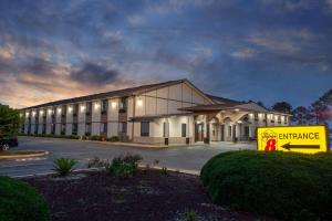 a large building with a sign in front of it at Super 8 by Wyndham Waycross GA in Waycross