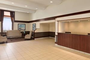 a large lobby with a waiting area with chairs and a waiting room at Travelodge by Wyndham Edmonton South in Edmonton
