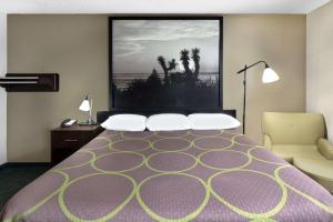 a hotel room with a bed and a large window at Super 8 by Wyndham Victoria/North/Mall Area in Victoria