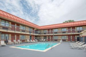 an exterior view of a hotel with a swimming pool at Super 8 by Wyndham Tulsa in Tulsa