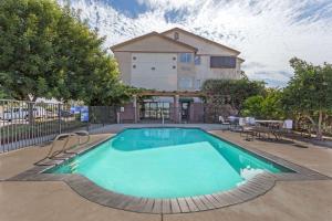 a swimming pool in front of a house at Super 8 by Wyndham Dixon/UC Davis in Dixon