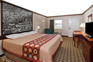 a hotel room with a large bed and a desk at Super 8 by Wyndham Ft. Oglethorpe GA/Chatt TN Area in Fort Oglethorpe