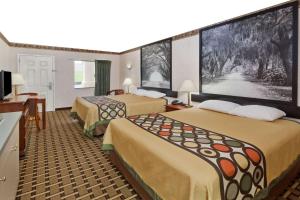 a hotel room with two beds and a flat screen tv at Super 8 by Wyndham Ft. Oglethorpe GA/Chatt TN Area in Fort Oglethorpe