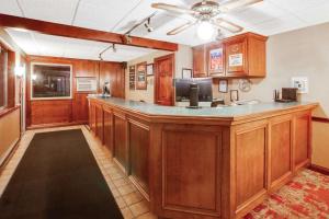 a bar in a room with a ceiling fan at Super 8 Beachfront by Wyndham Mackinaw City, MI in Mackinaw City