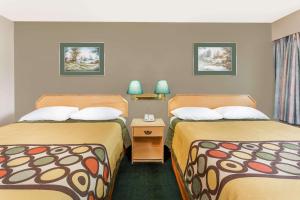 A bed or beds in a room at Super 8 by Wyndham Quesnel BC