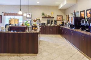 a large kitchen with brown cabinets and a counter at Ramada by Wyndham Camrose in Camrose