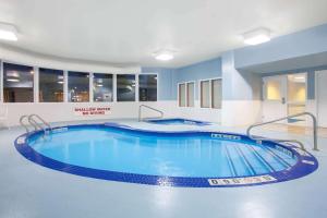 a large swimming pool in a hotel room at Super 8 by Wyndham Midland in Midland