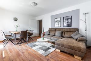 a living room with a couch and a table at Deluxe Apartments Friedrichstrasse in Freiburg im Breisgau +17 photos