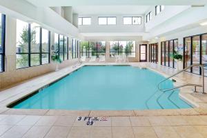 uma grande piscina num edifício com janelas em Wingate by Wyndham Atlanta Fairburn em Fairburn