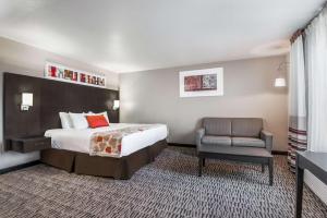 a hotel room with a bed and a chair at Hawthorn Suites Las Vegas in Las Vegas +63 photos
