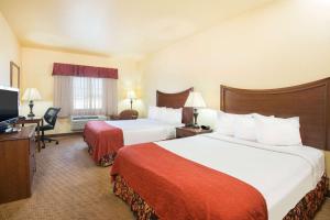 a hotel room with two beds and a television at Days Inn by Wyndham Ellis in Ellis +38 photos