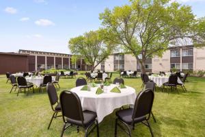 a group of tables and chairs on a grass field at Ramada by Wyndham Bismarck in Bismarck