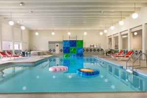a pool in a hotel with an indoor swimming pool at Ramada by Wyndham Bismarck in Bismarck