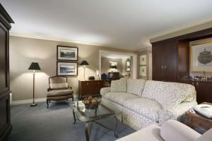a living room with a white couch and a chair at Days Inn by Wyndham Sidney OH in Sidney