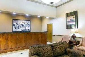 a lobby with a waiting room with a couch and chairs at Super 8 by Wyndham Longview/North in Longview