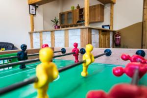 a group of rubber toy men playing a game of pool at Bakterház Vendégház in Nagyvisnyó