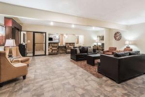 a large living room with couches and chairs at Super 8 by Wyndham Clovis in Clovis