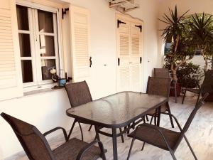 a dining room with a glass table and chairs at Leonidio Climb2red home in Leonidio